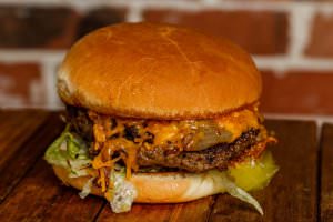 One (1/2 lb.) patty served with grilled onions, BBQ sauce, and cheddar cheese, bottomed with lettuce, tomatoes, and pickles. Your choice of condiments.