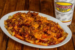 Fries with shredded cheddar cheese and chili.