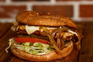 Marinated grilled chicken breast served with swiss cheese, grilled onions, on a wheat bun, bottomed with lettuce, tomatoes, and pickles. Your choice of condiments.