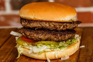 Two ( 1/2 lb.) patties bottomed with lettuce, tomatoes, onions, and pickles. Your choice of condiments.