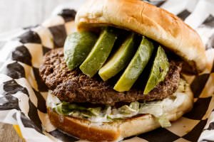 One (1/2 lb.) patty served with sliced avocado and drizzled with homemade ranch dressing, bottomed with lettuce, tomatoes, onions, and pickles. Your choice of condiments.