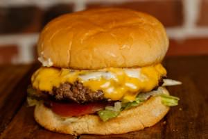 One (5 oz.) patty topped with american cheese, bottomed with lettuce, tomatoes, onions, and pickles. Your choice of condiments.